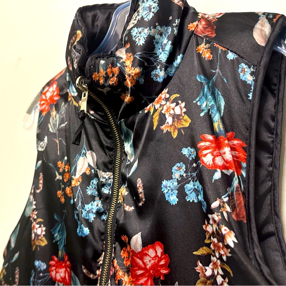 Winter vest black with printed red and blue pattern/flowers. Size L.